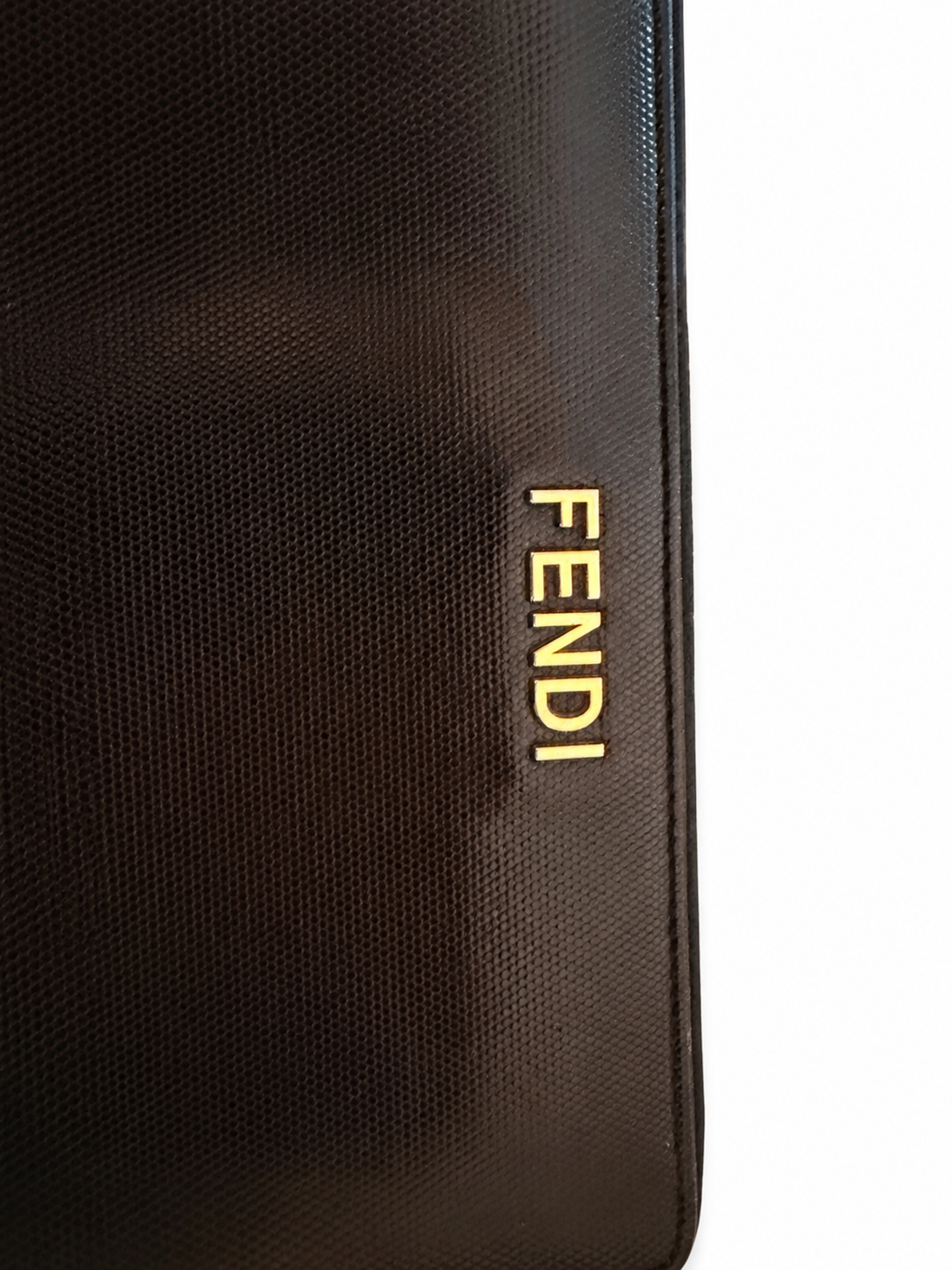 black Fendi zip-around continental wallet featuring a gold-toned metal logo plaque on the exterior