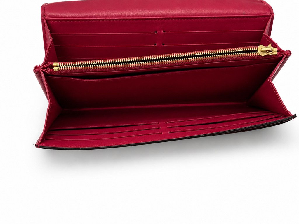 Louis Vuitton long wallet crafted in glossy red patent leather with a large gold-tone LV logo on the front.