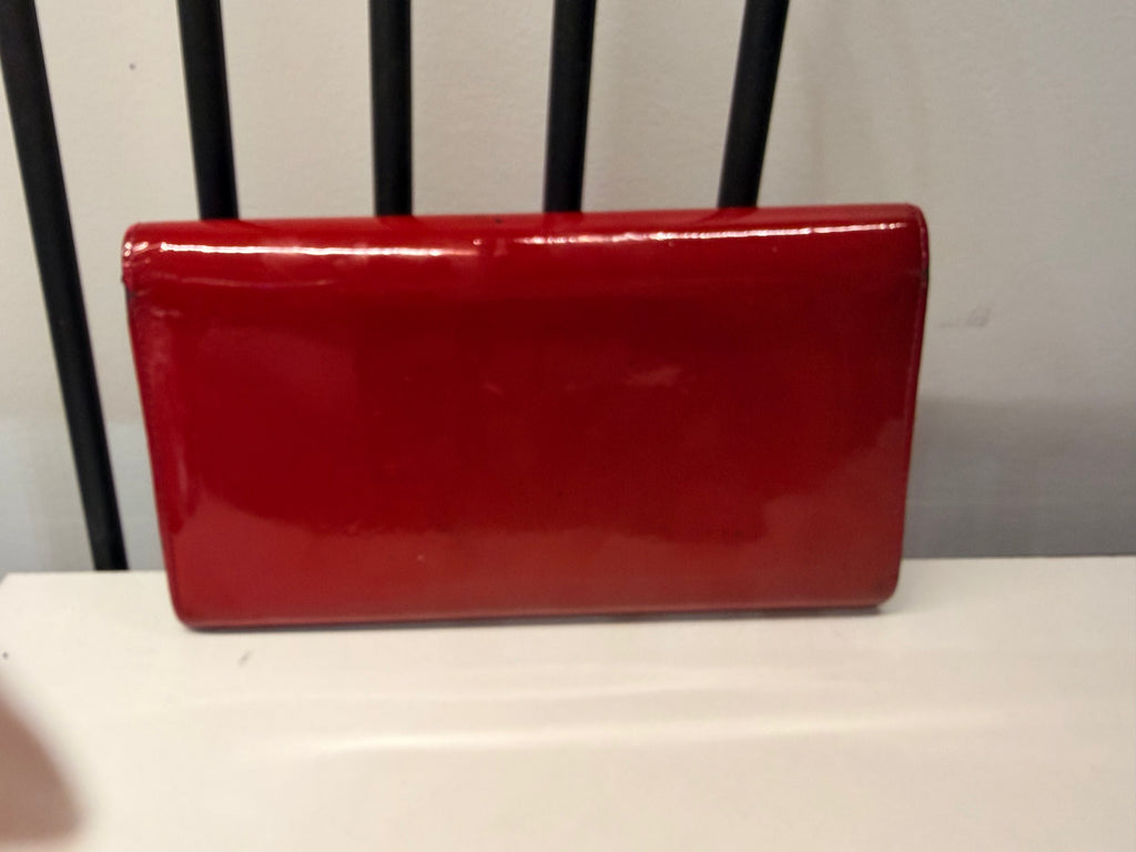 Louis Vuitton long wallet crafted in glossy red patent leather with a large gold-tone LV logo on the front.