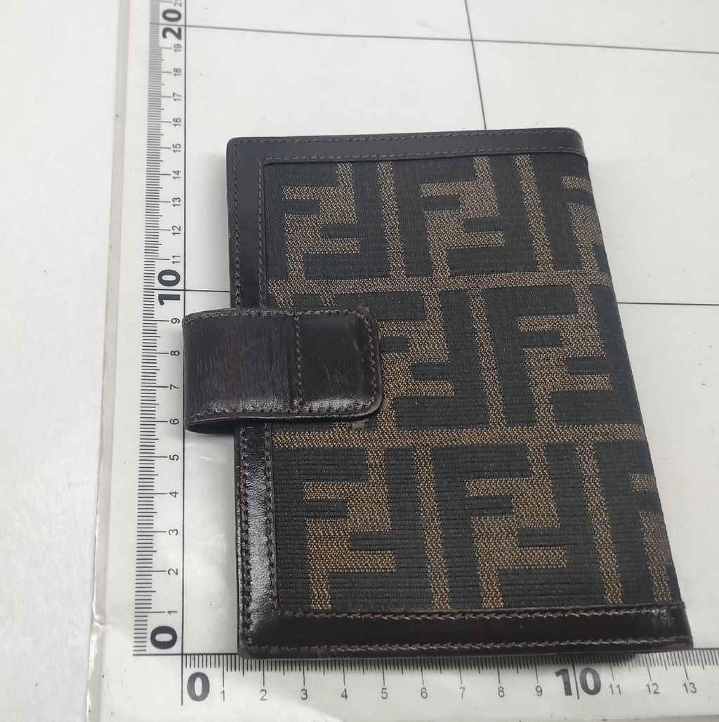 vintage Fendi agenda cover featuring the iconic brown and black Zucca FF monogram canvas with dark brown leather trim.