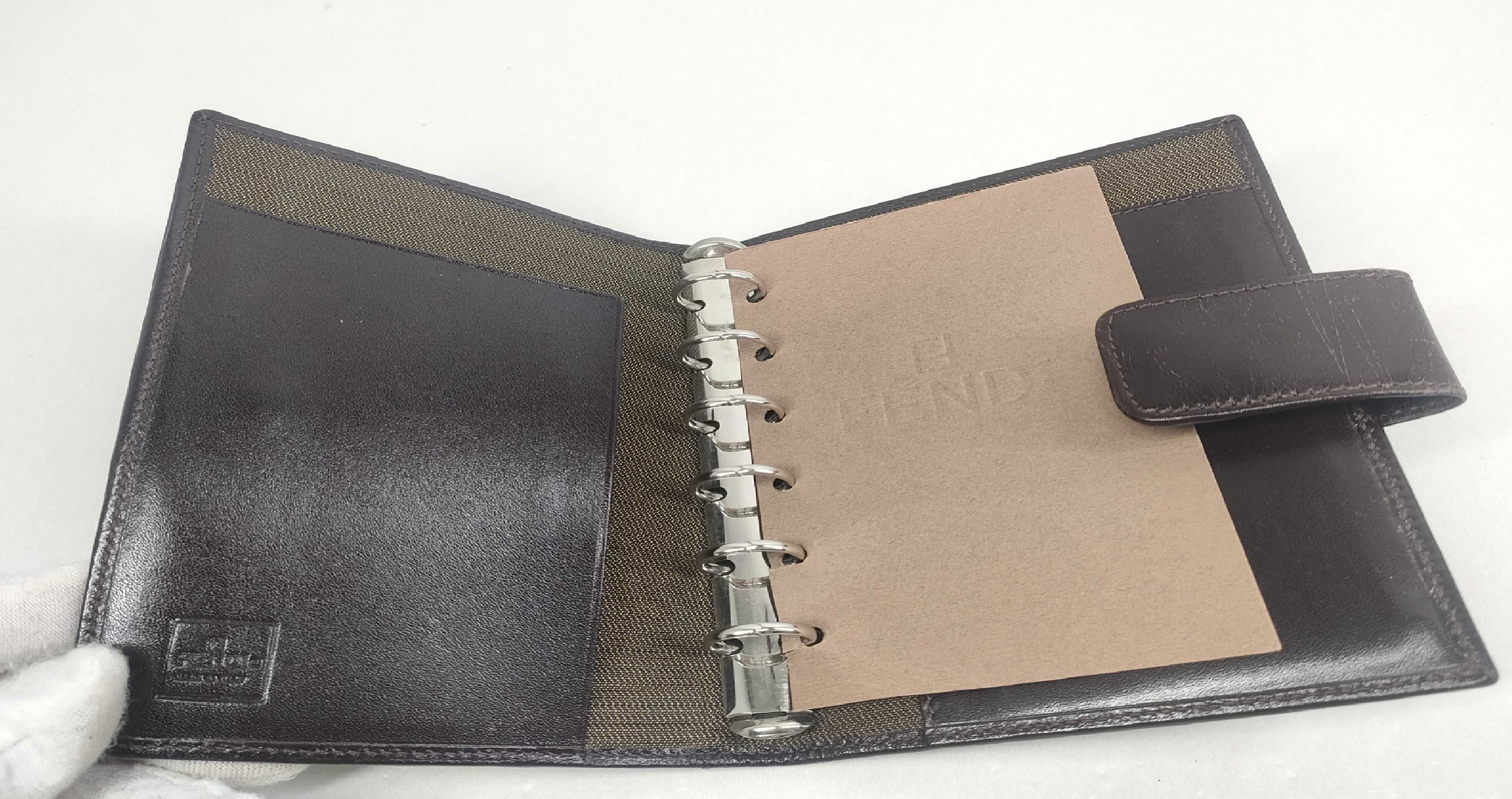 vintage Fendi agenda cover featuring the iconic brown and black Zucca FF monogram canvas with dark brown leather trim.