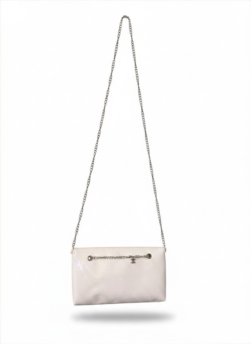 Chanel Beauty Bag features a white patent leather exterior with a prominent pink logo design
