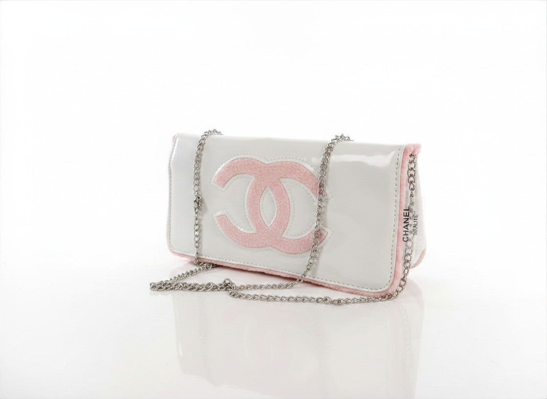 Chanel Beauty Bag features a white patent leather exterior with a prominent pink logo design