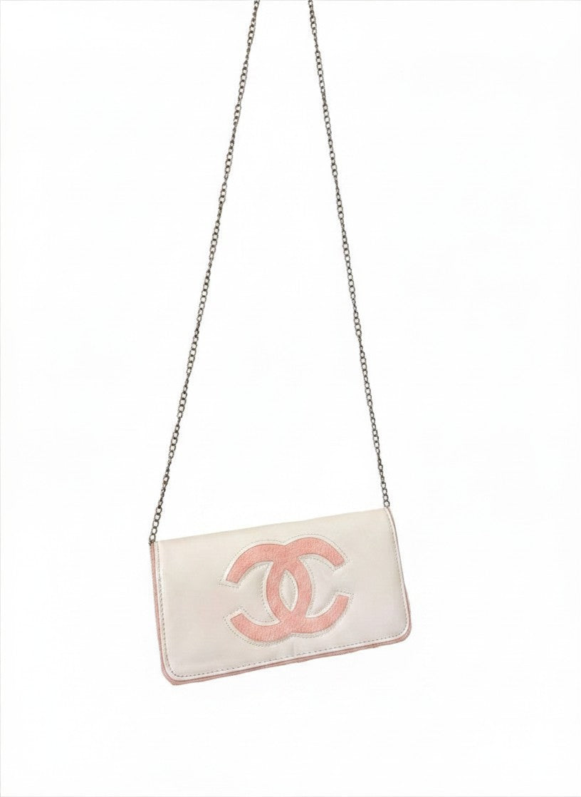 Chanel Beauty Bag features a white patent leather exterior with a prominent pink logo design