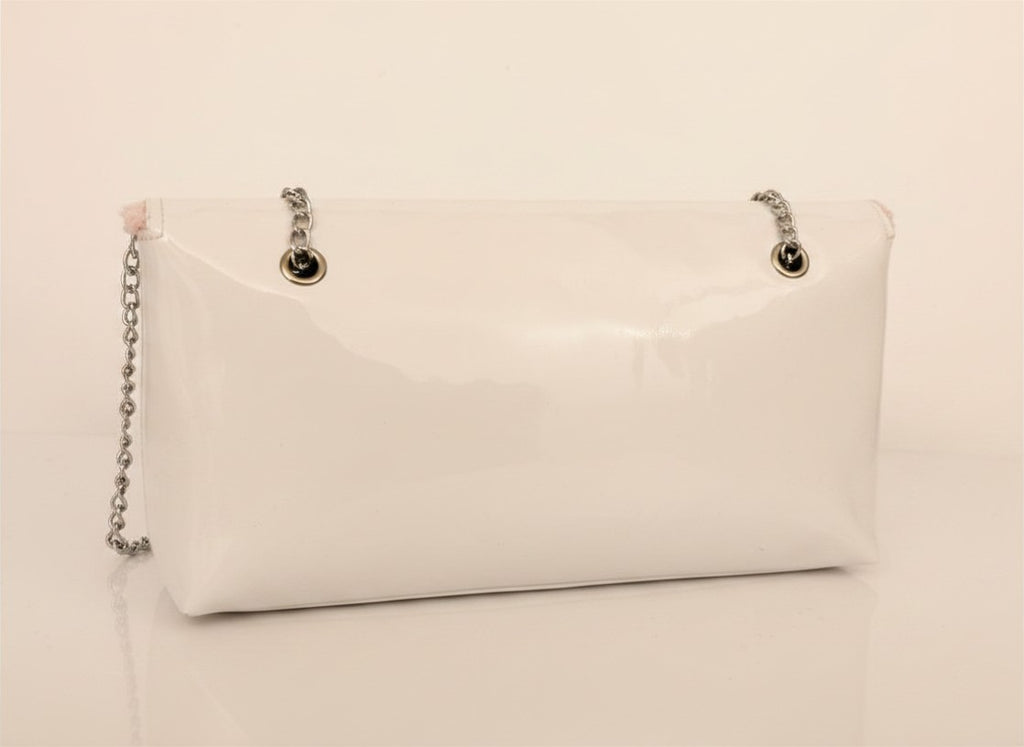 Chanel Beauty Bag features a white patent leather exterior with a prominent pink logo design