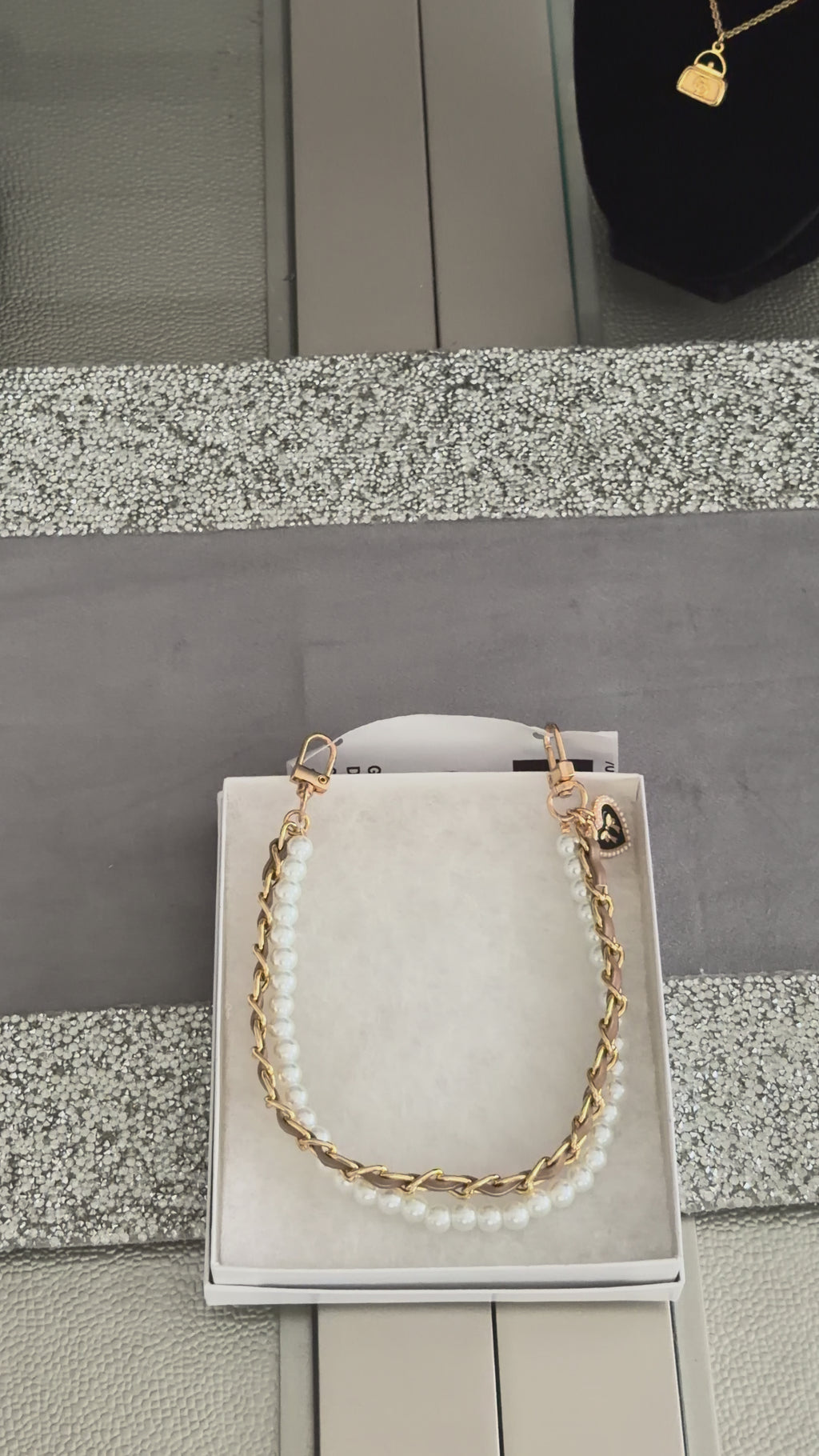 Golden Darling Strap" by Charmed Dollhouse features a mixed-media design combining a warm gold chain with a strand of lustrous pearls.